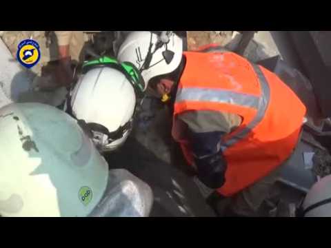 Rescue teams recover people from rubble after suspected Russian air strikes hit Idlib