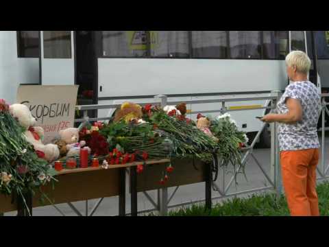 Russia: people lay flowers, soldiers stand guard outside Kazan school