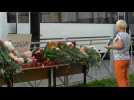 Russia: people lay flowers, soldiers stand guard outside Kazan school