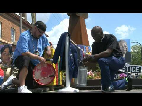 People take a knee at George Floyd memorial on anniversary of his death