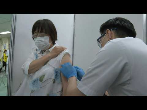 Eldery receive Covid-19 shots as mass vaccination center opens in Tokyo