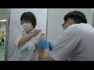 Eldery receive Covid-19 shots as mass vaccination center opens in Tokyo