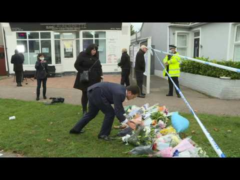People lay flowers following the murder of British MP David Amess