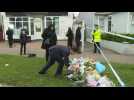 People lay flowers following the murder of British MP David Amess