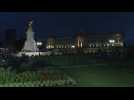 Crowds gather outside Buckingham Palace at night