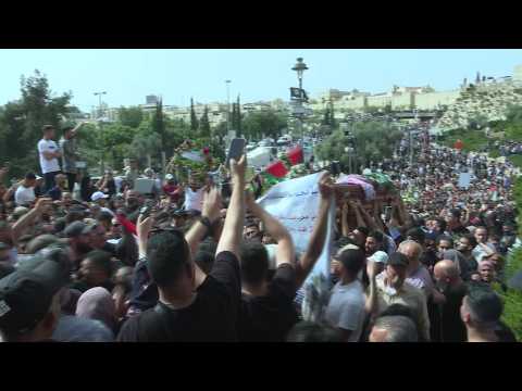 Palestinian mourners carry the coffin of slain Al Jazeera journalist outside Jerusalem's Old City