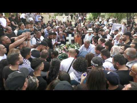 People gather at Mt Zion cemetery where slain Al Jazeera journalist is laid to rest