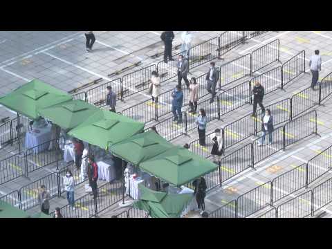 Beijing residents queue for Covid tests as city seals off neighbourhoods