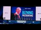 Uzbekistan President Mirziyoyev greets supporters on stage after election victory
