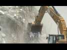Excavators dig through rubble of Nigeria's collapsed building