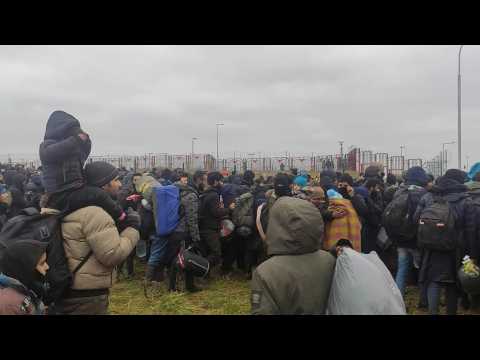 Dozens of migrants arrive and wait at the Belarus-Poland border crossing
