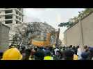 Excavator digs through rubble of collapsed Lagos high-rise in Nigeria