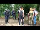 Party-goers leave the site of an illegal mass rave in France