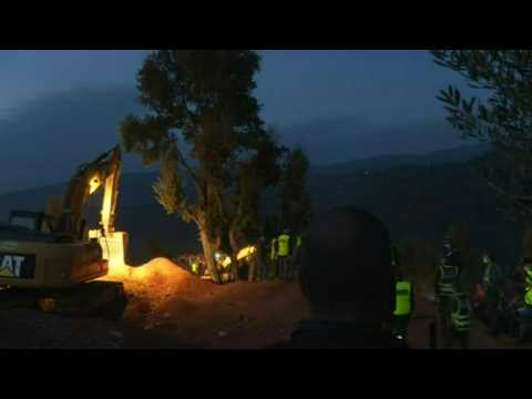 Bystanders watch as Moroccan authorities work to rescue boy trapped in well