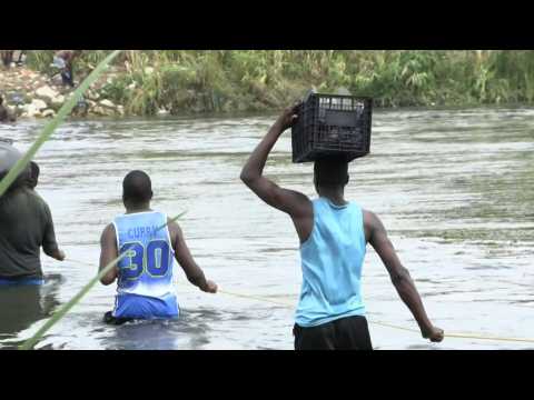 Migrants cross Rio Bravo river between Mexico and the US