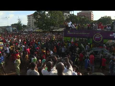 Supporters greet exiled opponents arriving at Conakry airport after fall of Conde
