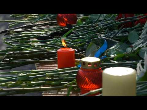 Flowers and grief at Russia university campus after gunman kills six people