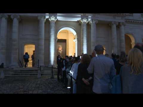 People gather in front of Belmondo's coffin at the Invalides in Paris