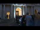 People gather in front of Belmondo's coffin at the Invalides in Paris