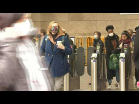 Commuters exit London station as face masks compulsory again on English public transport