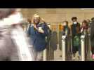 Commuters exit London station as face masks compulsory again on English public transport