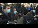 Former French justice minister mobbed by supporters during visit to Saint Denis near Paris