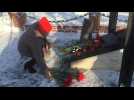 People lay flowers at memorial to rescuers after deadly accident in Siberian coal mine