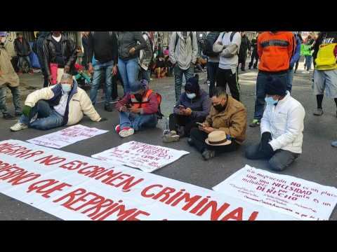Migrants part of a caravan protest in Mexico City