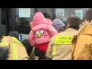 Ukrainians get off a bus in Polish town next to Ukraine border