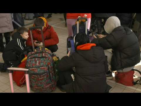 Ukrainian refugees wait at train station on Polish border