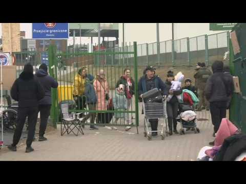 Refugees cross border from Ukraine into Poland