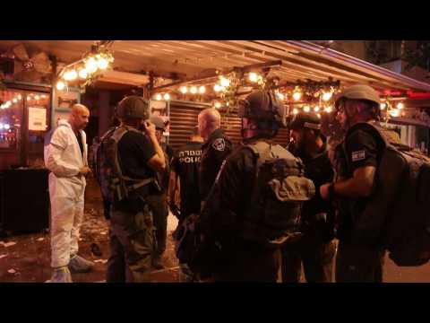 Israeli police and people gather at the scene of Tel Aviv attack
