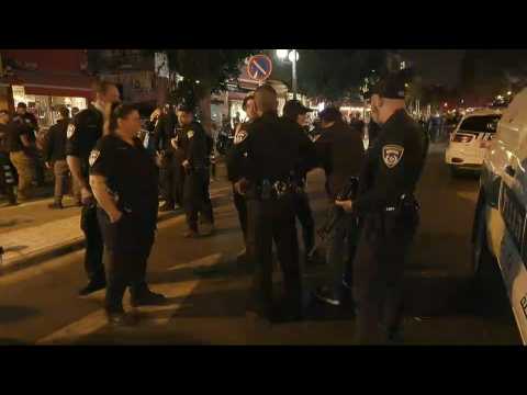 Israeli police and people gather at the scene of Tel Aviv attack
