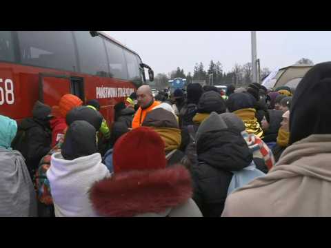 Ukrainian refugees wait for buses at Poland's border town
