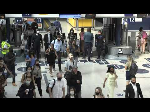 Commuters at London train station as England removes mask mandate