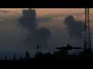 Smoke rises and rockets land in northern Gaza, seen from Israel