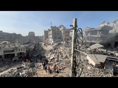 People inspect rubble at Gaza's Shati camp after air strikes