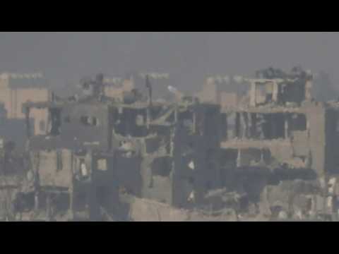 Israeli flag raised on top of destroyed building in northern Gaza