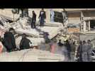 Emergency services clear rubble at the site of strike in Damascus