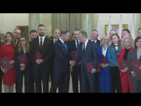 New Polish government poses for photo after Tusk sworn in as Prime Minister