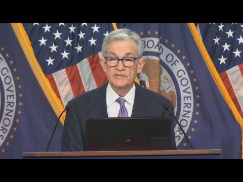 US Fed holds key lending rate, signals three cuts in 2024