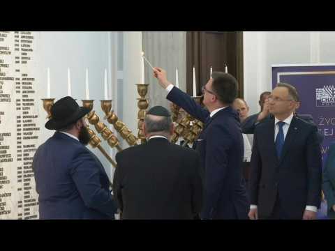 Poland's Duda takes part in ceremony relighting Hannukah candles doused by far-right lawmaker