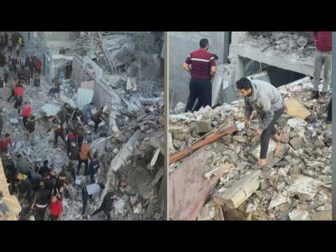 Palestinians inspect the rubble of destroyed buildings in Rafah refugee camp