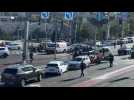 Security forces remove car used during a gun attack on bus stop in Jerusalem