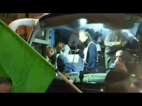 Crowd celebrates around bus with freed Palestinian prisoners on board
