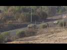 Israeli military vehicles and smoke billowing from northern Gaza Strip