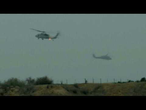 Israeli helicopters fly in and out of the Gaza Strip