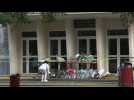 People lay flowers at French school where teacher slain by Islamist