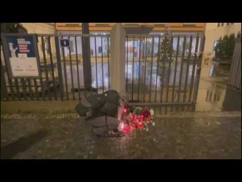 People light candles for victims of Prague shooting at makeshift memorial