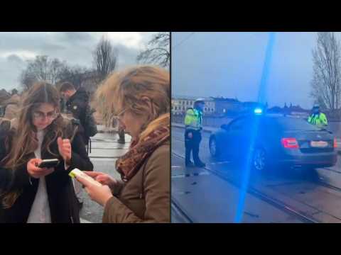 Bystanders, police vehicles near Czech university where deadly shooting occurred